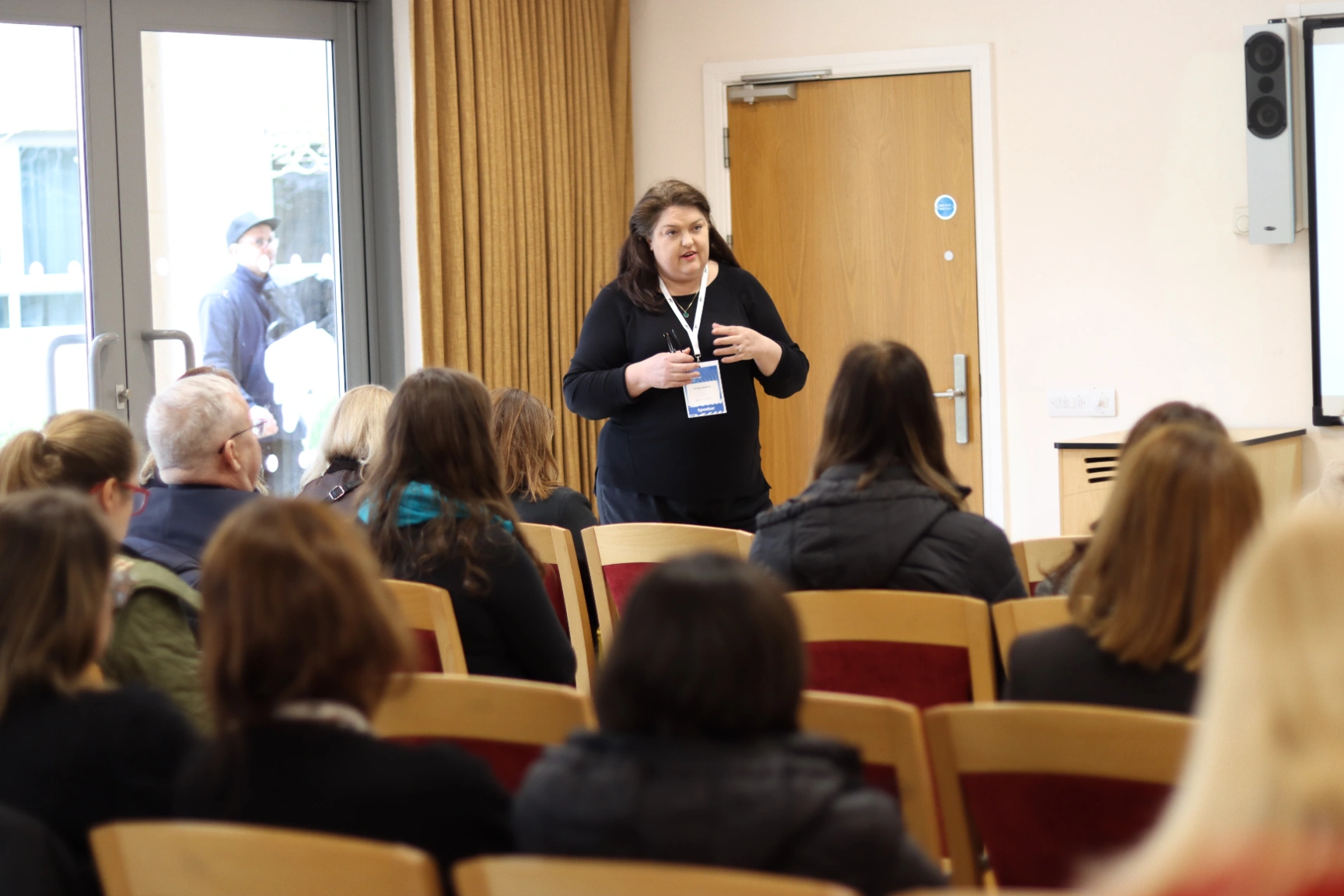 A participant asking a question with a microphone